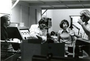 one female and three males working in the optics lab.