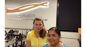 Two females standing in optics lab.